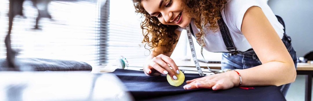 The beautiful tailor working on the table